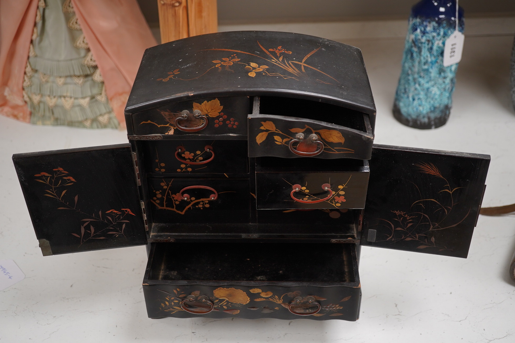 A late 19th early 20th century Japanese lacquer cabinet, 31cm high. Condition - exterior chipped and cracked near the top edge